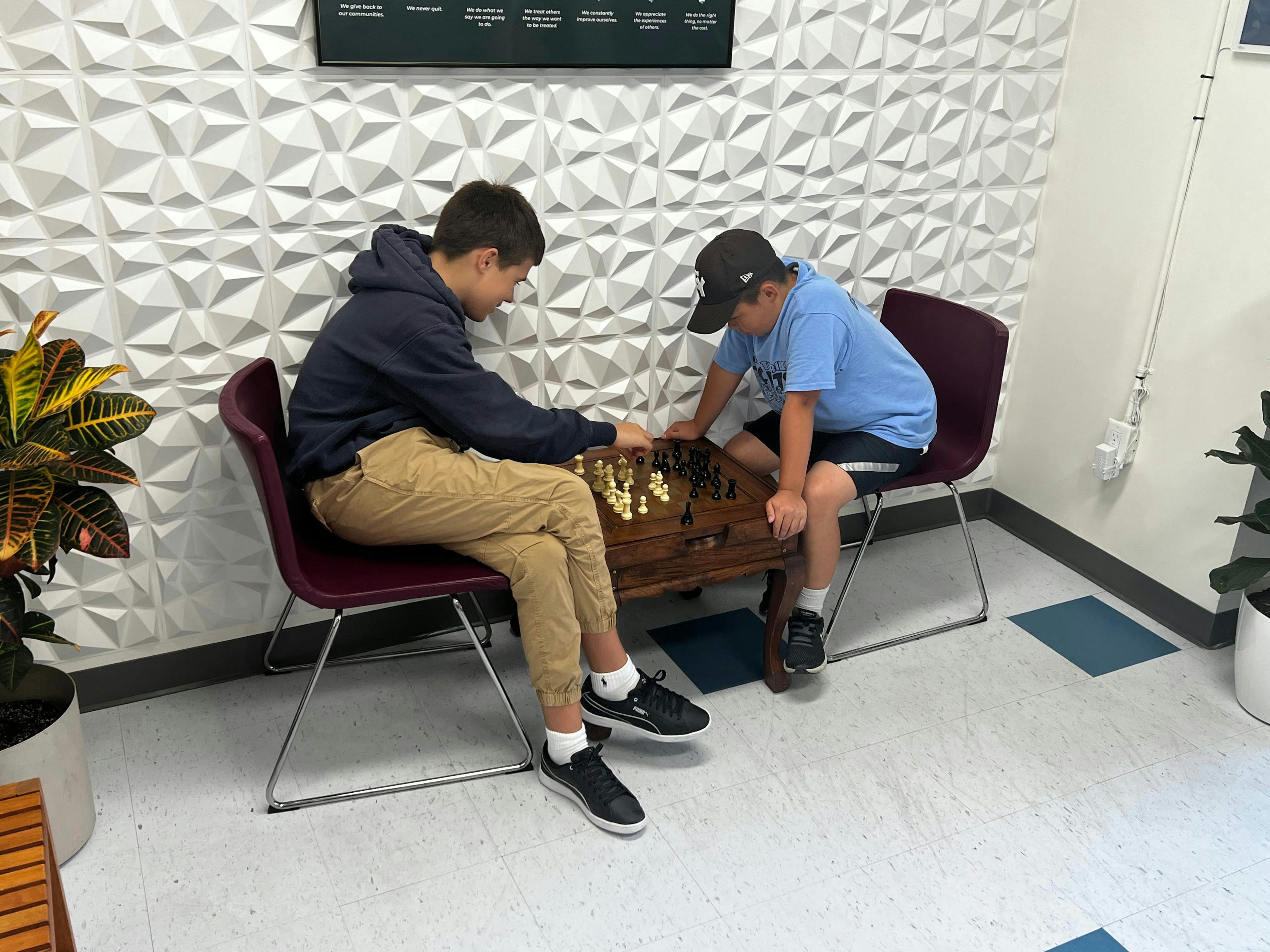 two ATI Toronto students playing chess.